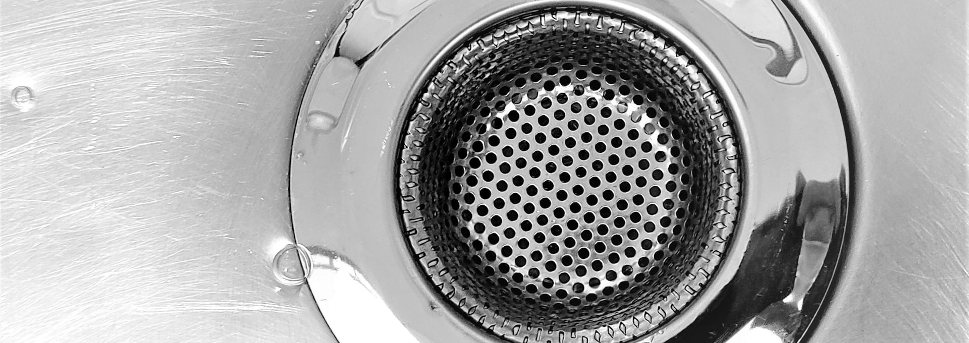 Close-up of a stainless steel kitchen sink drain strainer